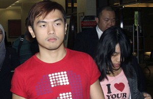 Ethnic Chinese Alvin Tan, left, and Vivian Lee walk at a court house in Kuala Lumpur, Malaysia, Thursday, July 18, 2013. Prosecutors have charged Tan and Lee, who are both non-Muslims, with sedition and inciting religious enmity after they posted a photograph on Facebook considered an insult to the Muslim holy month of fasting. They face up to eight years in prison if convicted of both charges in the Muslim-majority nation.(AP Photo) MALAYSIA OUT